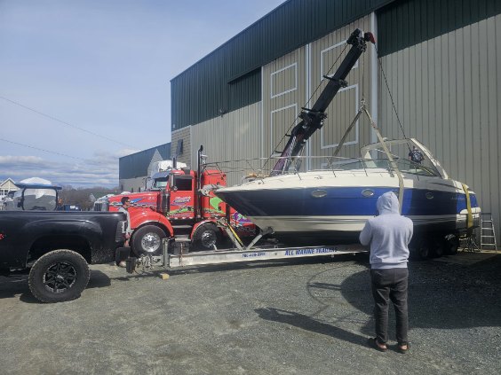 Boat transport, boat lift by crane hoist, oversized load boat transport, power only, boat on tri axle bunk trailer by Logi Transport. 