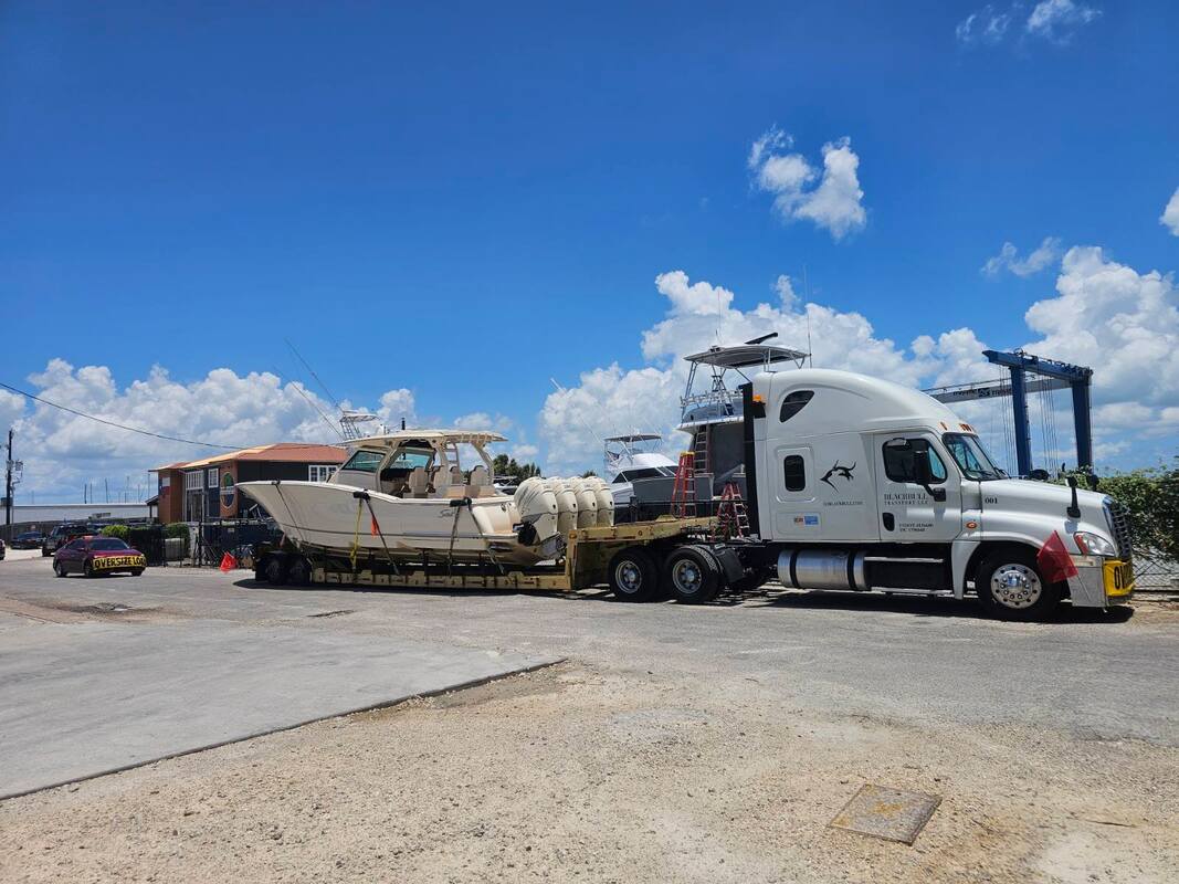 Oversized boat loaded on lowboy boat trailer.