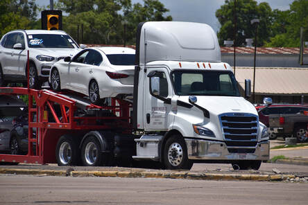 Double deck car hauler fully loaded.