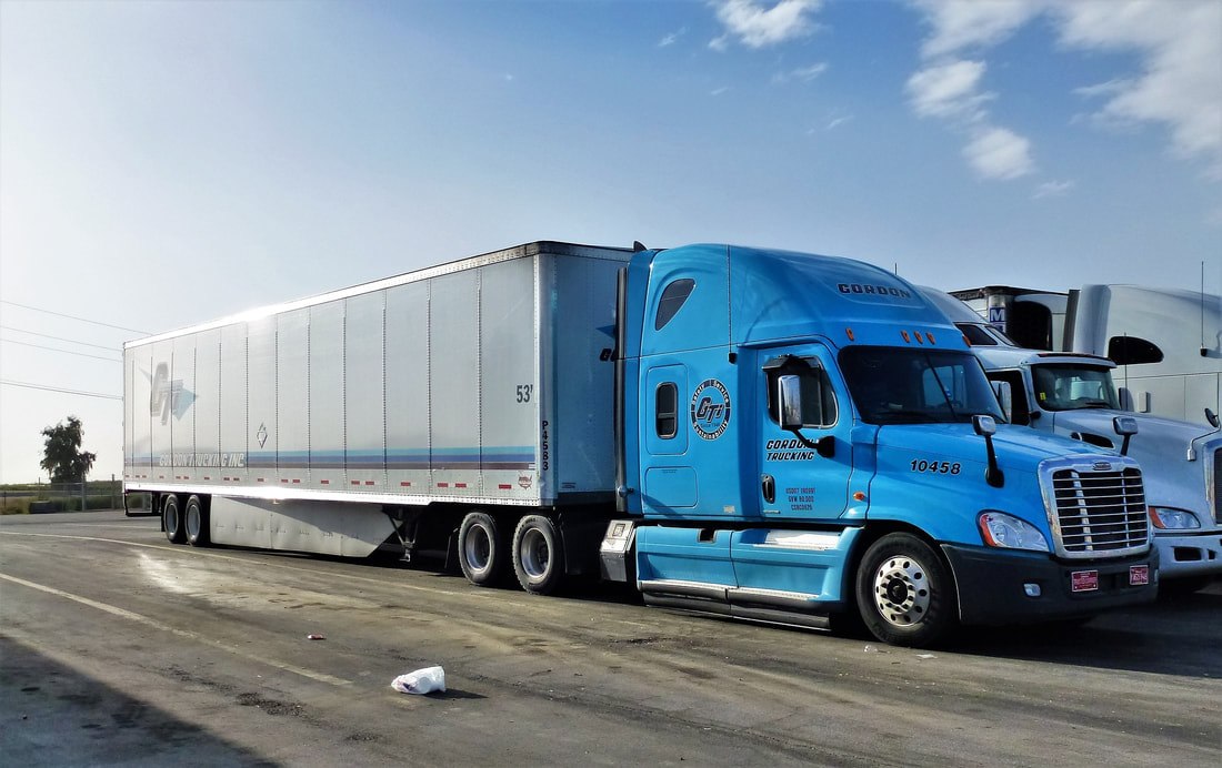 Semi with dry van trailer, parked. 