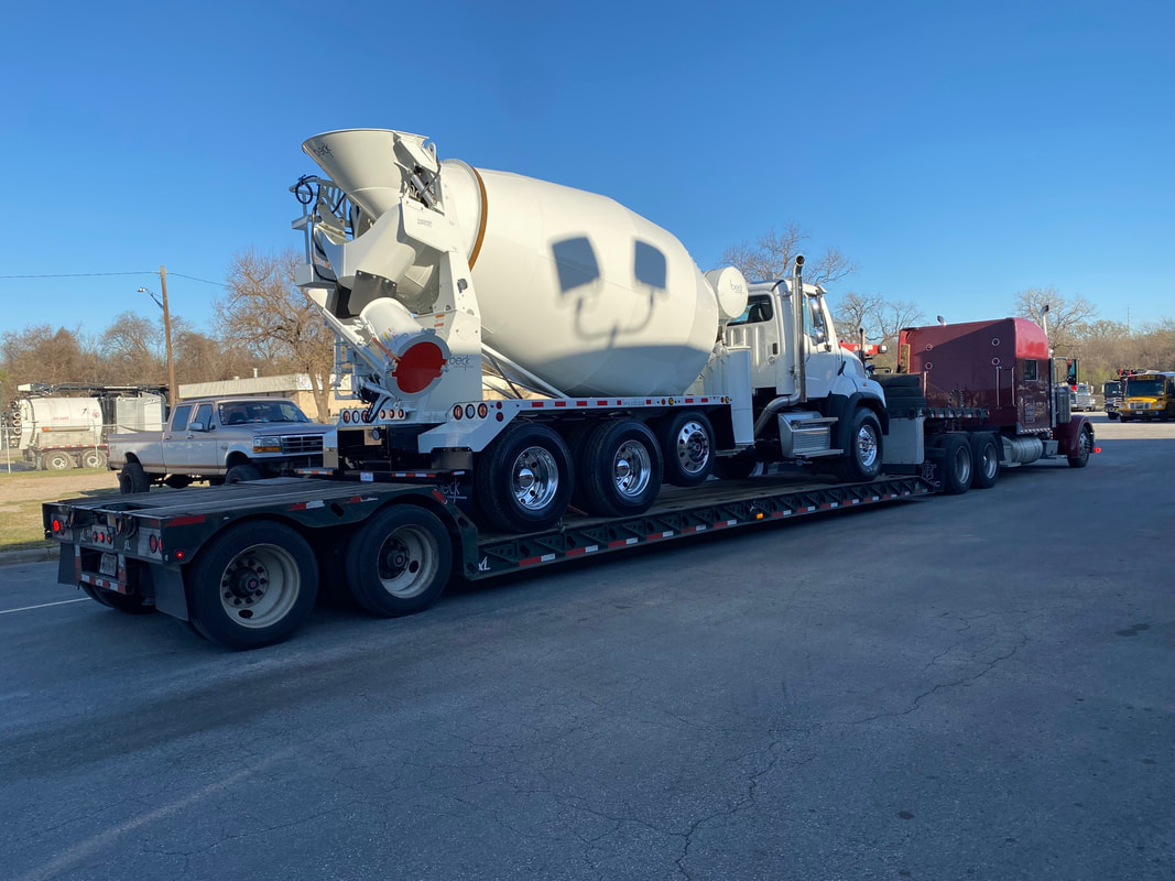 Cement mixer loaded on 5 axle RGN trailer.