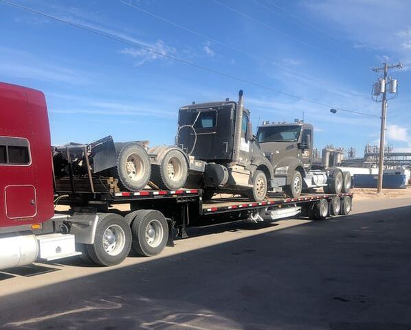 Heavy equipment transport, semi truck transport, step deck trailer transport as full load and 2 sets of ramps by Logi Transports 